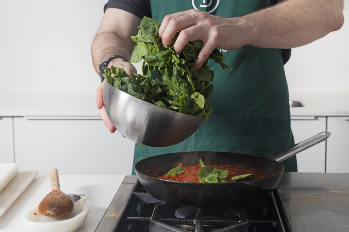 Shakshuka with Spinach and Puttanesca Sauce and Sun-Dried Tomato Spread by Alberto Rey — Delicious & Sons