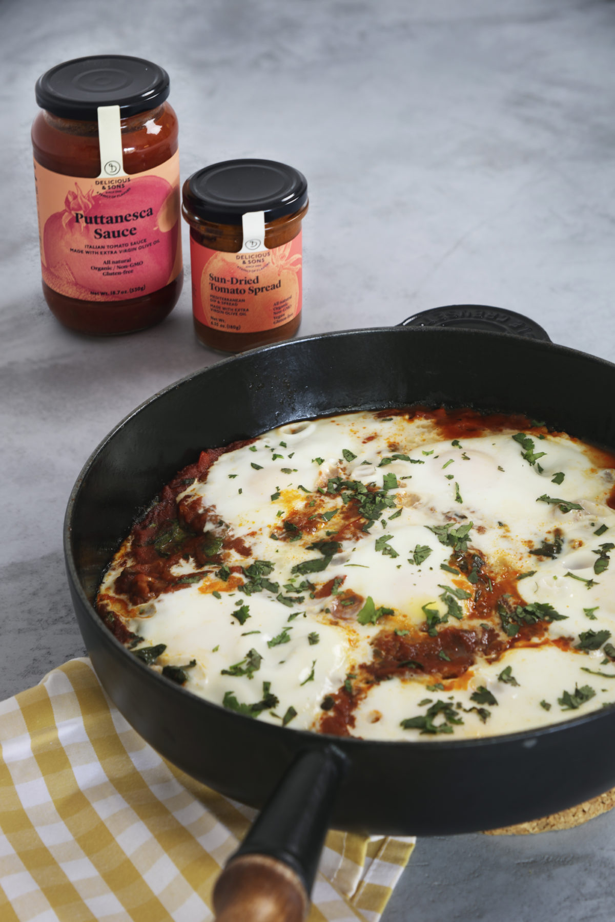 Shakshuka with Spinach and Puttanesca Sauce and Sun-Dried Tomato Spread by Alberto Rey — Delicious & Sons